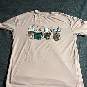 A pink woman’s shirt with coffee designs